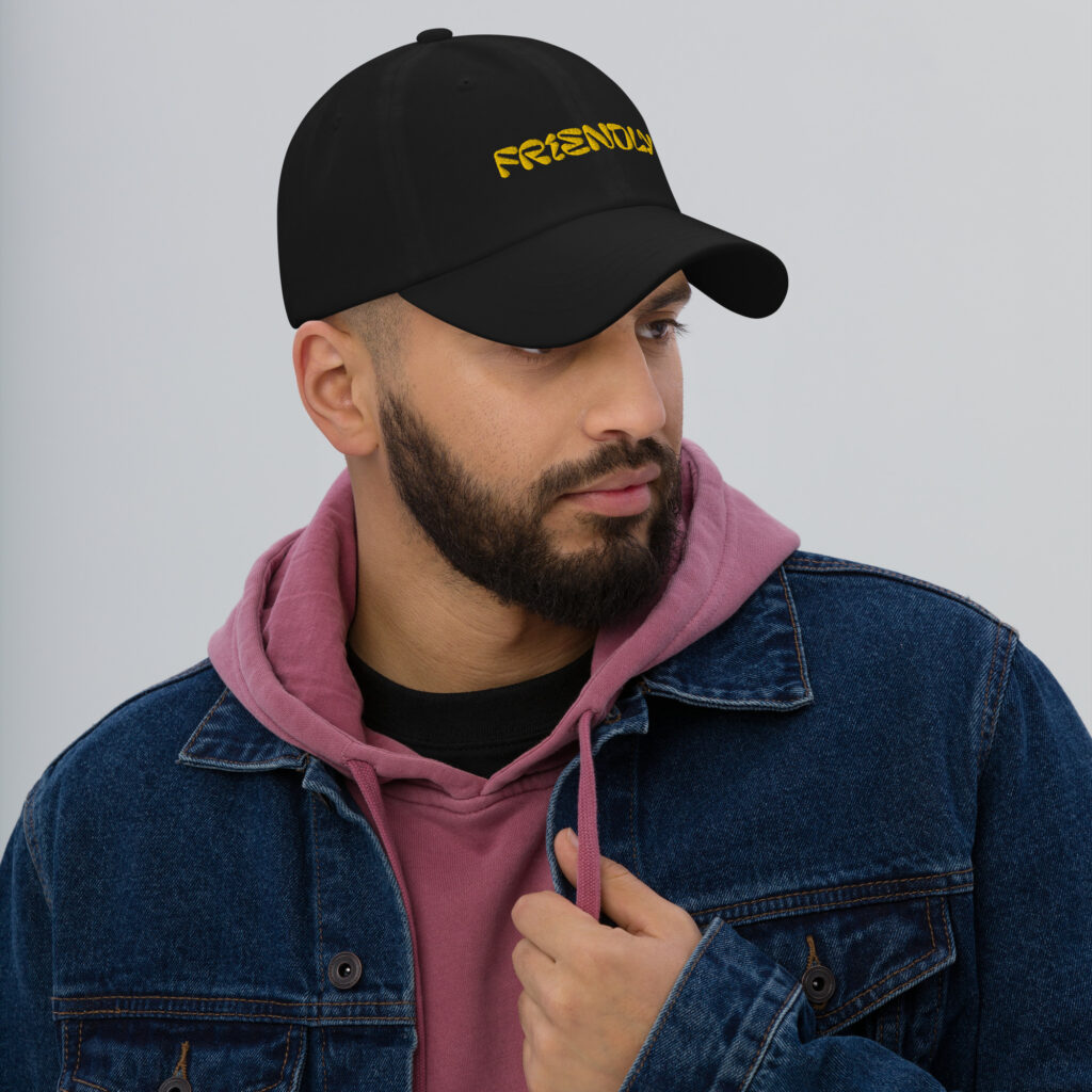 Male model wearing Black Friendly Gear Dad Hat - Yellow